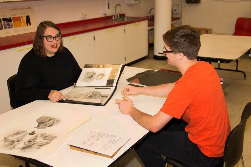 A student receives feedback from artist Amy Greenan (left) during the 2015 AK Teens Portfolio Review Day sessions