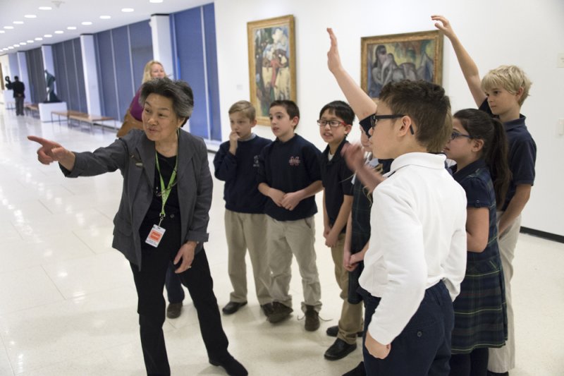 Docent Dorothy Tao leads students on a tour of the museum