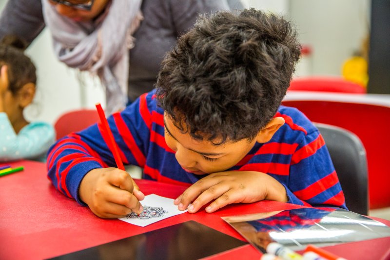 A boy making art in the classroom