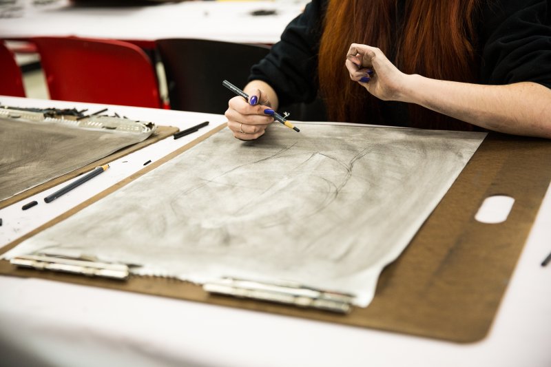 A girl drawing in the classroom