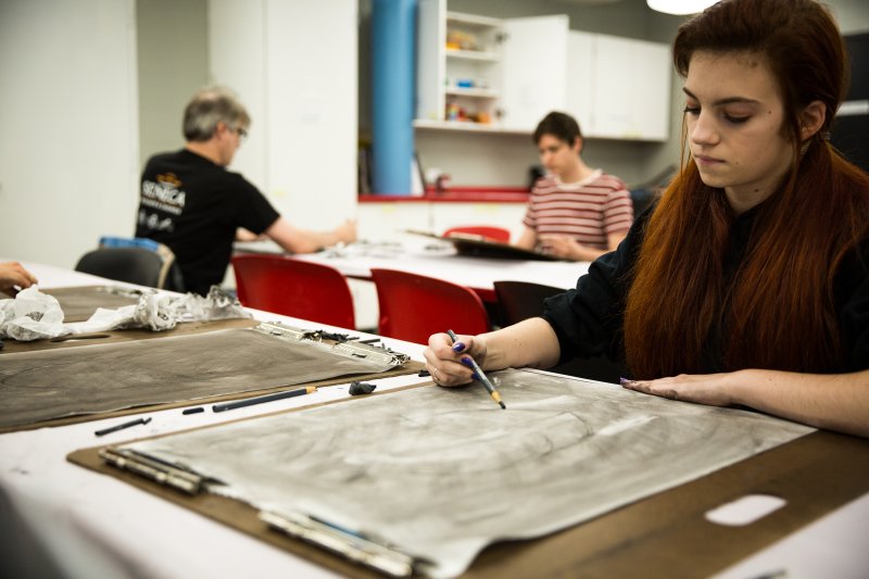 A young woman drawing in the classroom
