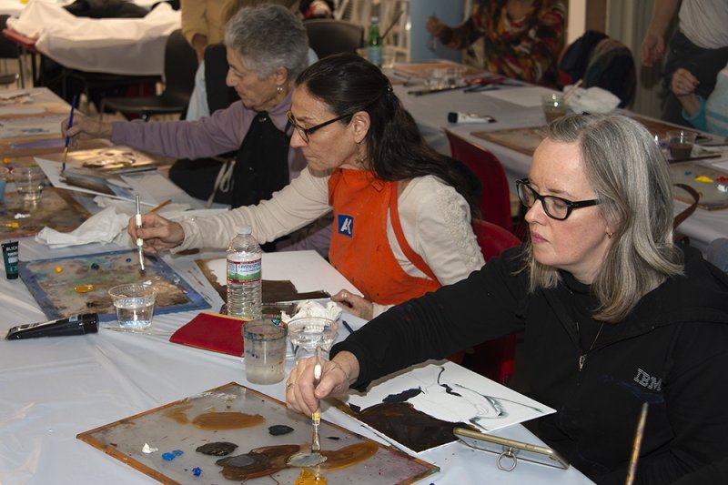 Adults working on art projects in the classroom