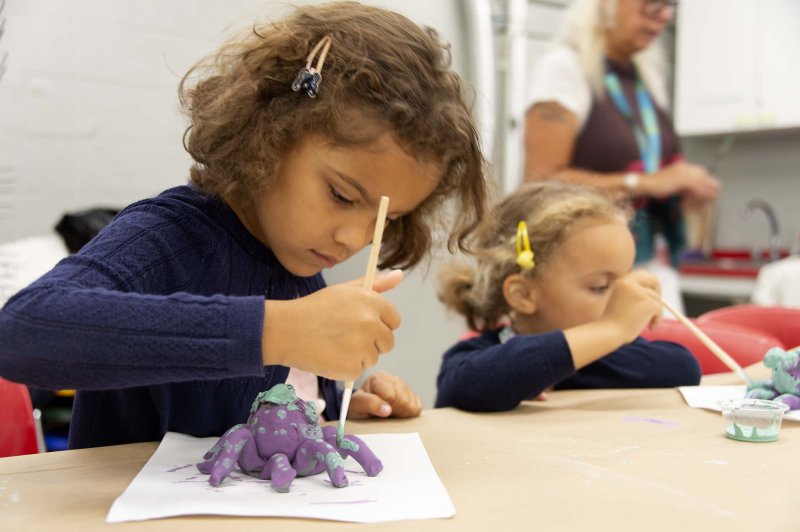 Two young girls making sculptures
