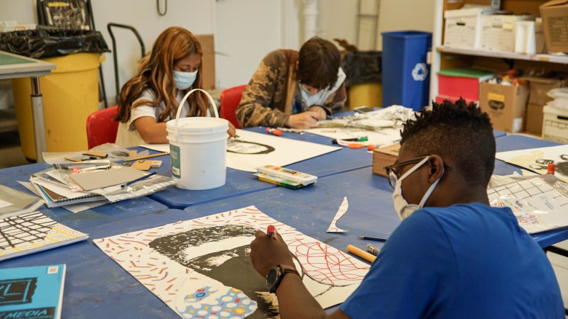 Three teens making art