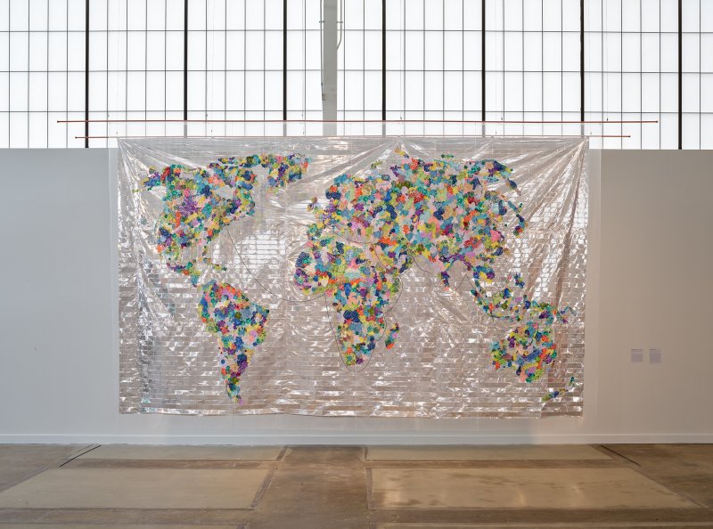 A map of the world with the continents made of pieces of colored fabric flowers