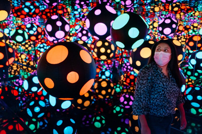 Visitor in one of Yayoi Kusama's mirrored rooms