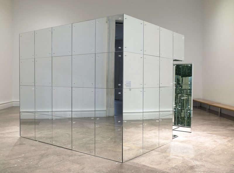 A large art installation that is a squared room with mirrors panelling all of the walls on the outside and inside. 