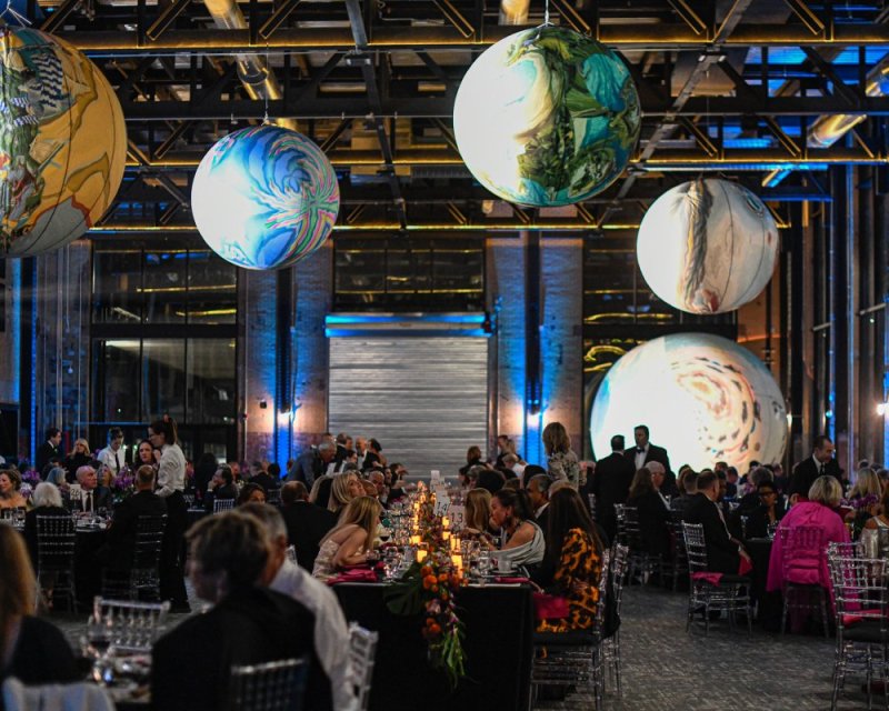 Guests sit under works by Anne Spalter at AKGala 2021 at The Powerhouse