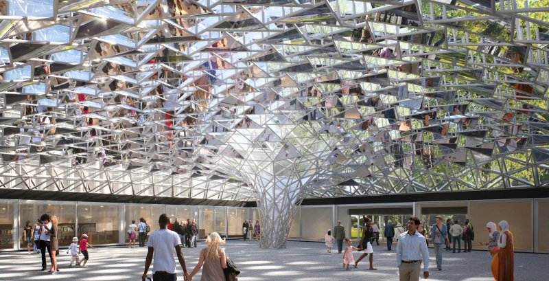 Glass funnel ceiling in a large open space with people walking around 