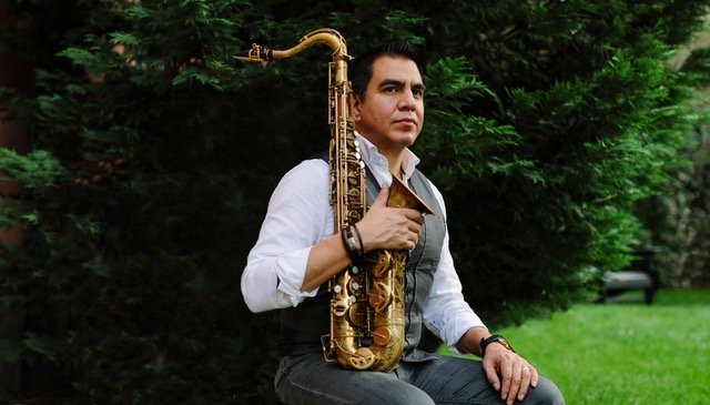 Diego Rivera holding a saxophone