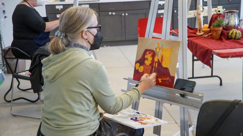 A woman painting a still life