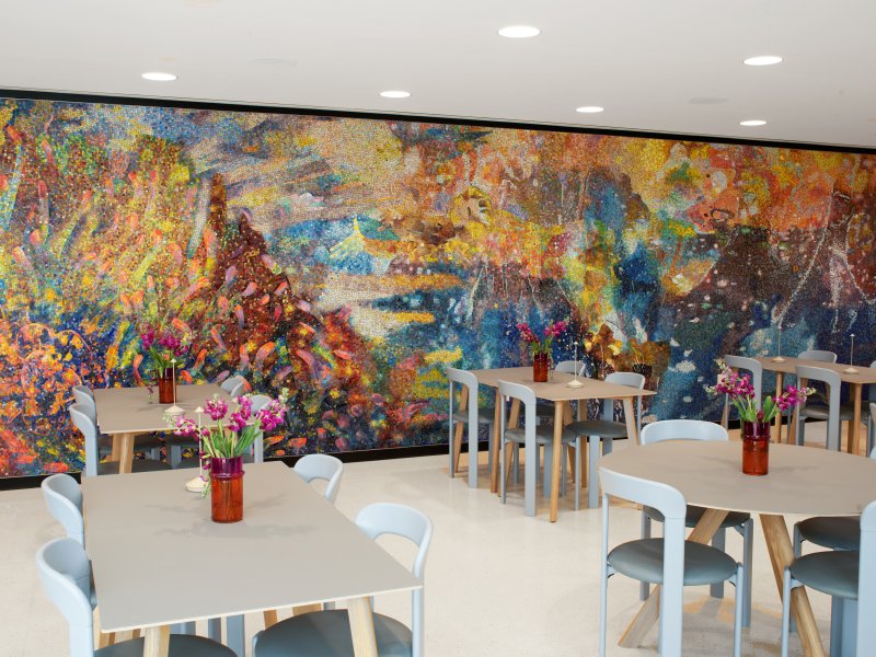 Rainbow mosaic on a wall in a cafe