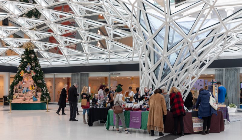 A pop up holiday shop under a glass canopy ceiling 