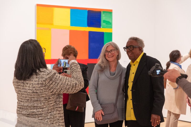 Two people posing for a photo in an art gallery
