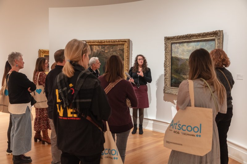 A group of adults on a tour in an art gallery