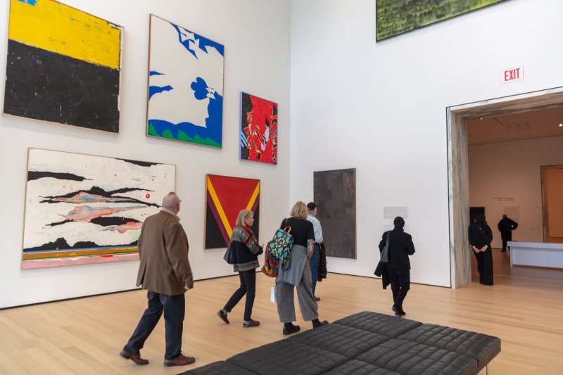 People walking through a large art gallery