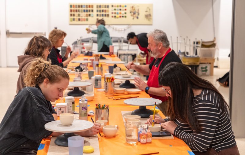 A group of adults in a clay class