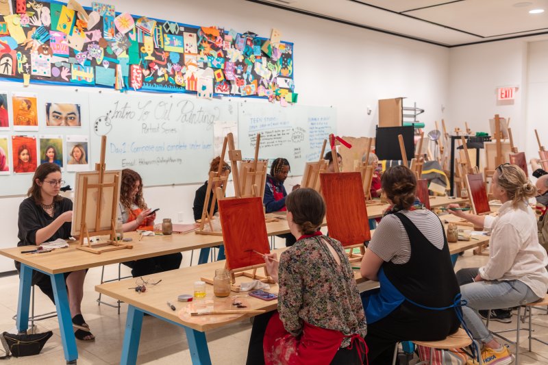 An oil painting class taking place in an art studio