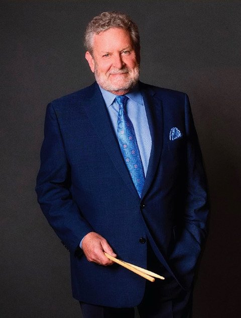 A headshot of an older man in a suit