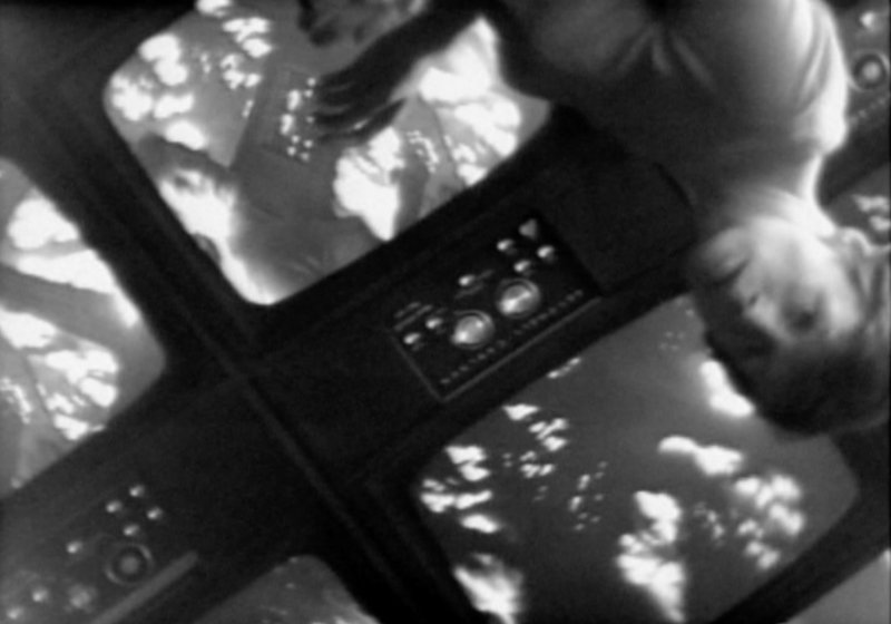 Black and white still of a person upside down