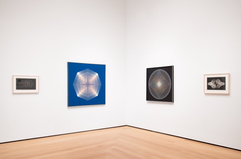 Installation view of Op art works on white gallery walls