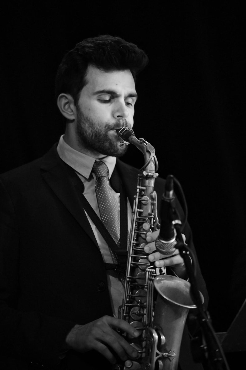 Black and white photo of a person playing the saxophone