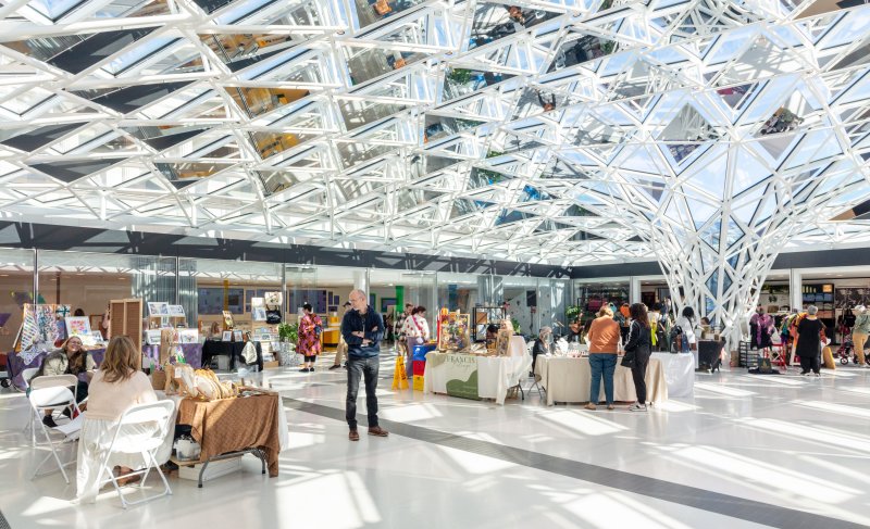 Vendors set up under a glass mosaic ceiling 