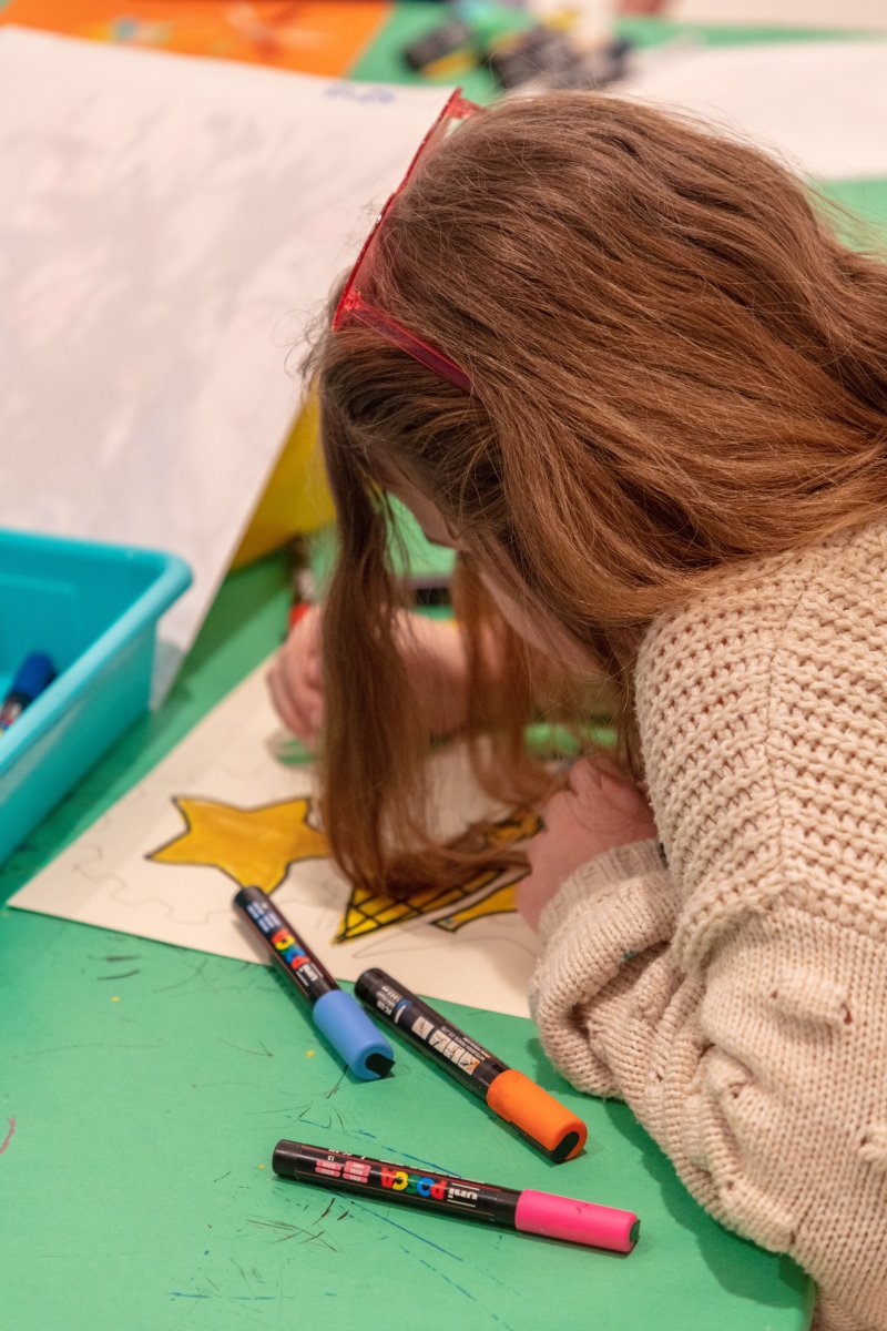 A person drawing on a green table