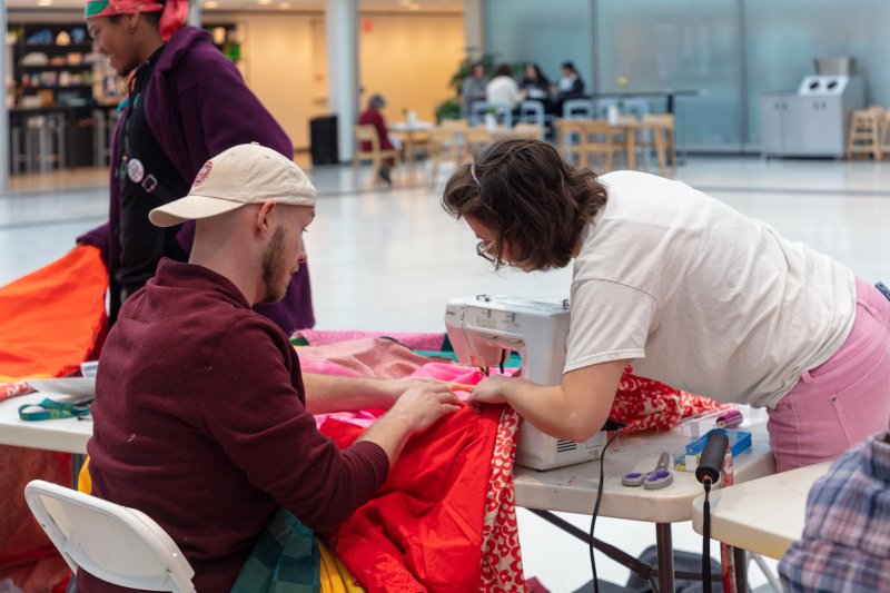 Two people working on a sewing project
