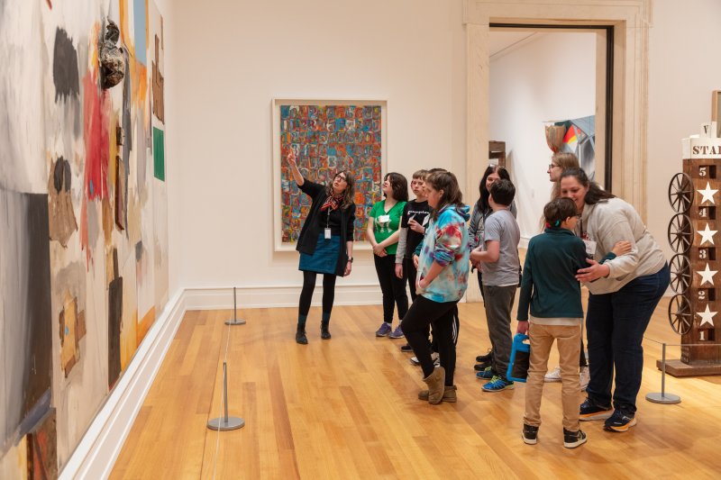 A group tour taking place in an art gallery