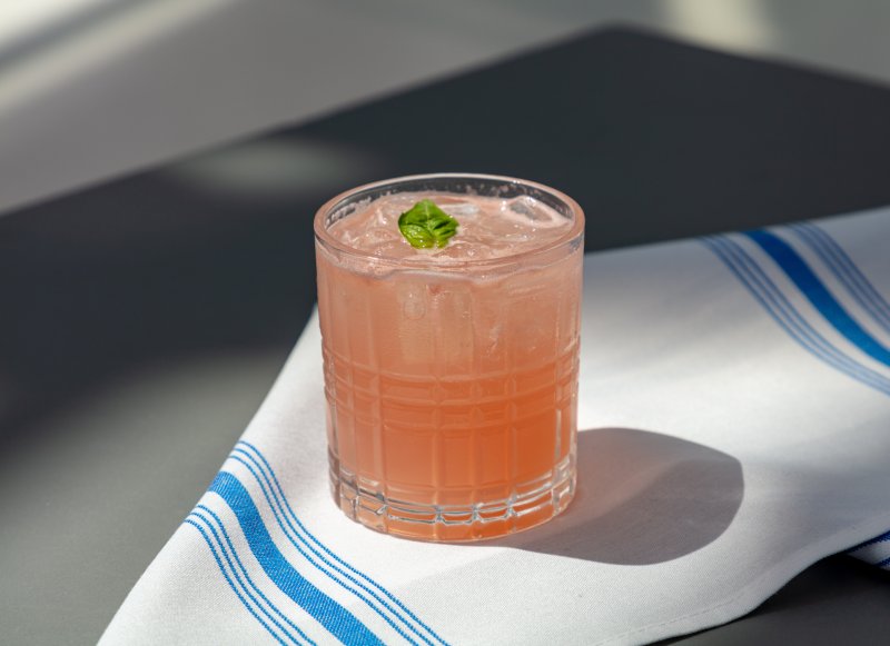 A peach cocktail on a white napkin