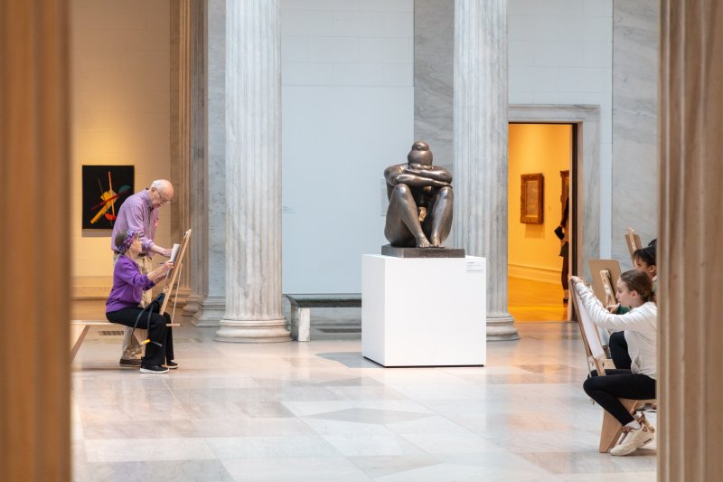 People drawing in an art gallery