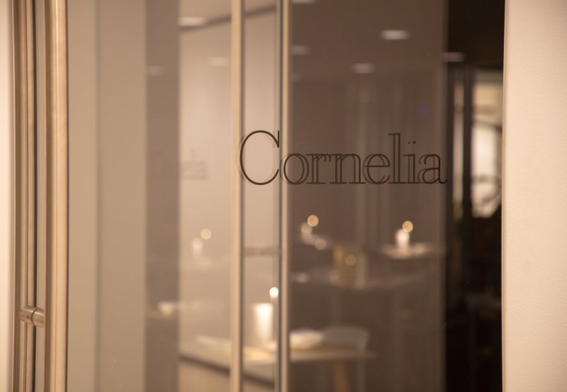 A view of a glass door with Cornelia printed on it