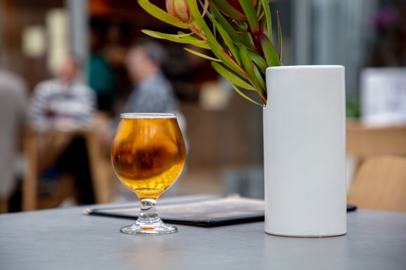 A glass of beer sitting on a table