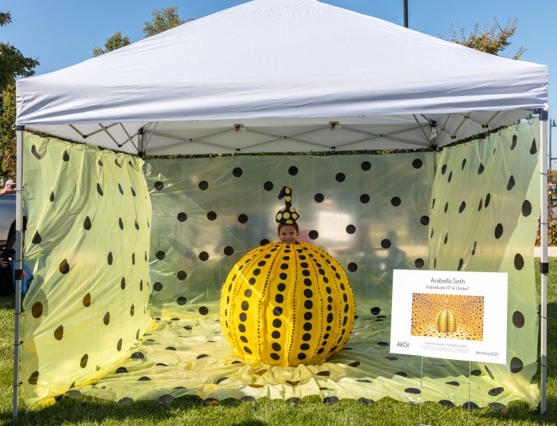 A young person dressed as a pumpkin inspired by artist Yayoi Kusama