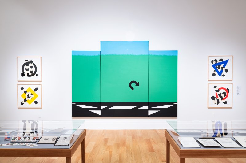 White gallery wall with vibrant artworks 