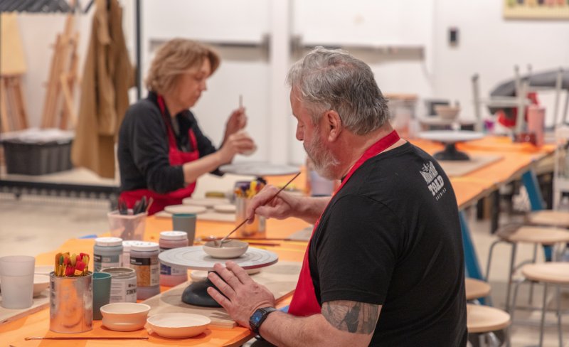 People working in a pottery class