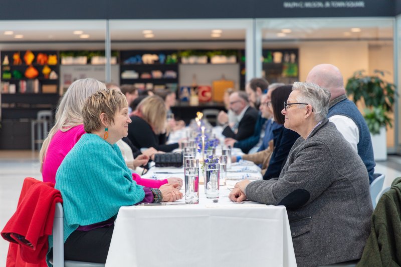 People dining at a long table