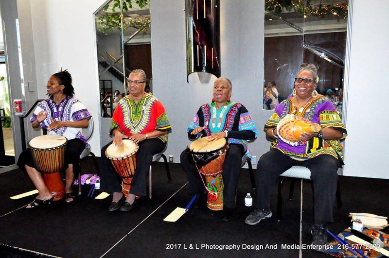 Four people playing drums