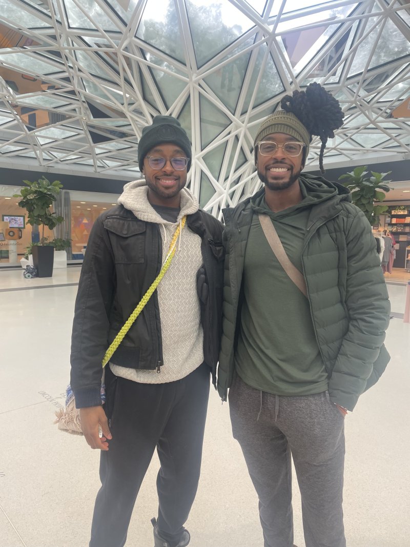 Two people standing and smiling