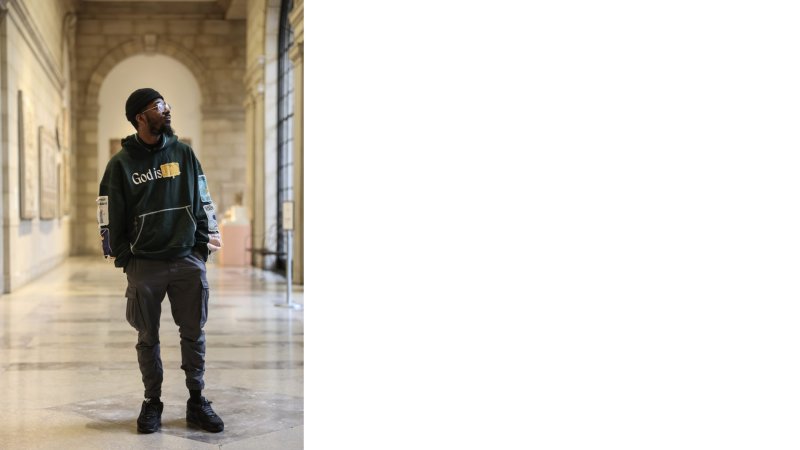 A person wearing all black in a marble building