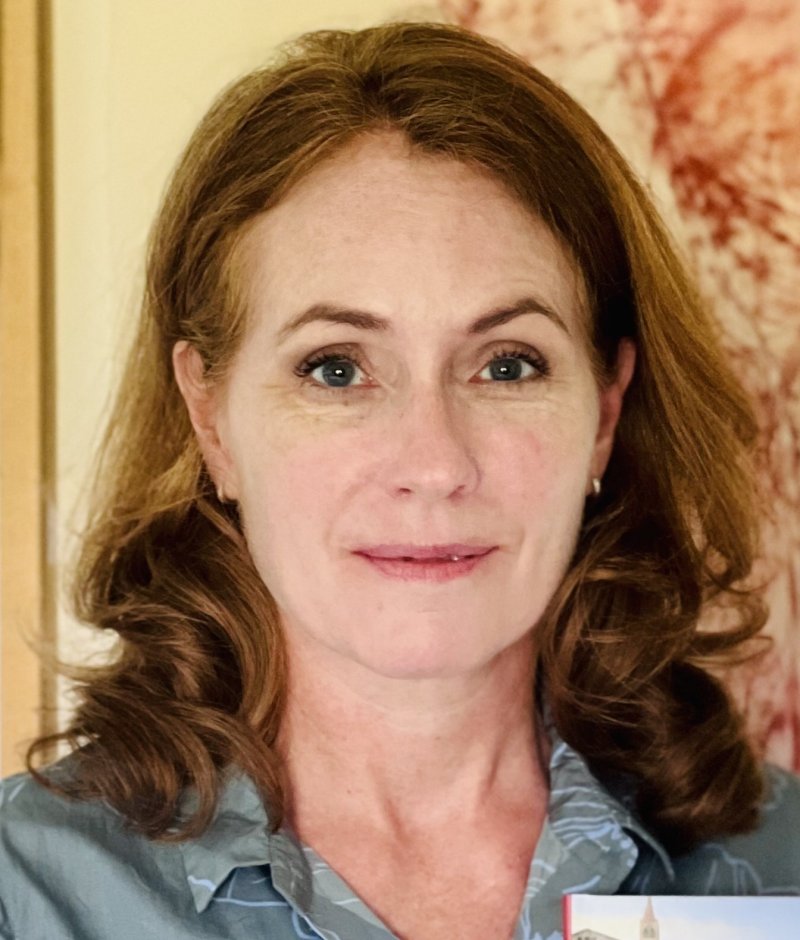 Headshot of a person with shoulder length brown hair