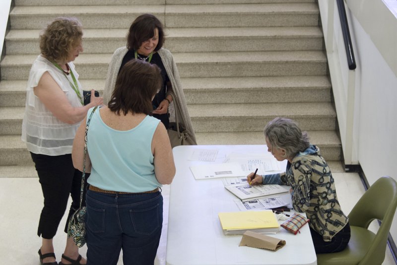 Artist Joan Linder draws near the entrance to the Clifton Hall Link where her exhibition Joan Linder: Operation Sunshine is on view.