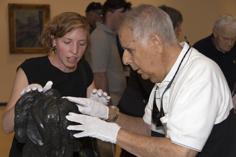 Accessibility and Community Programs Coordinator Teri Fallesen guides a visually impaired guest as part of the Veterans Connecting through Art program