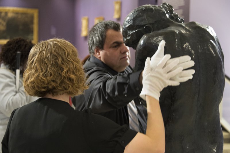 Accessibility and Community Programs Coordinator Teri Fallesen guides a visually impaired guest touching August Rodin's Eve during a Verbal Description Sensory Tour.