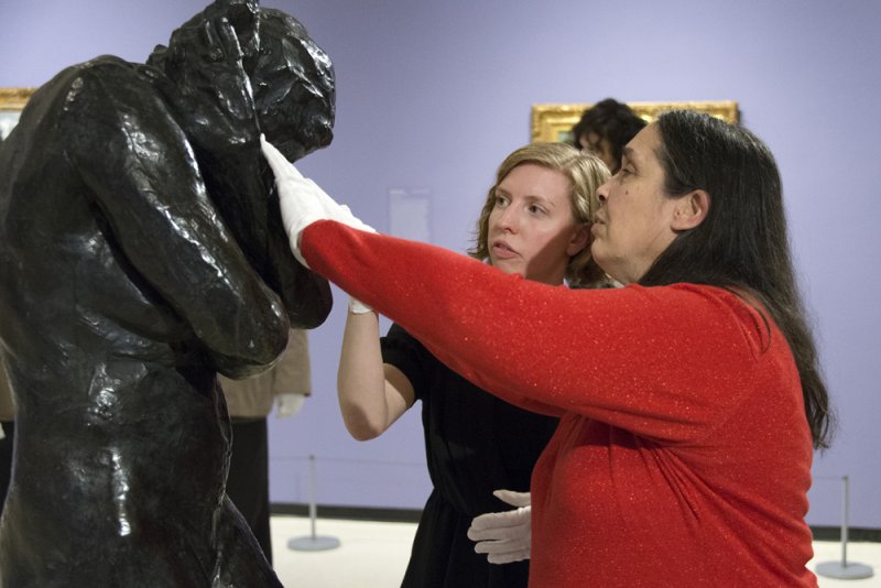 Accessibility and Community Programs Coordinator Teri Fallesen guides a blind woman touching August Rodin's Eve during a Verbal Description Sensory Tour.