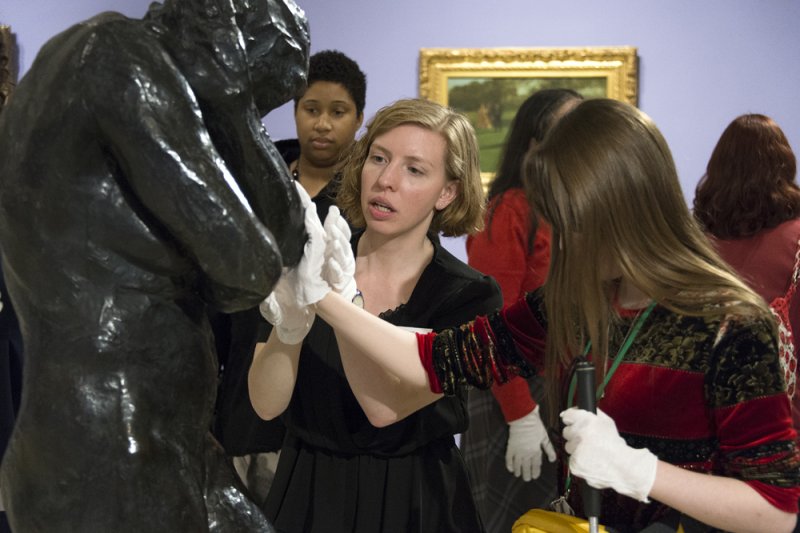 Accessibility and Community Programs Coordinator Teri Fallesen guides a blind woman touching August Rodin's Eve during a Verbal Description Sensory Tour.