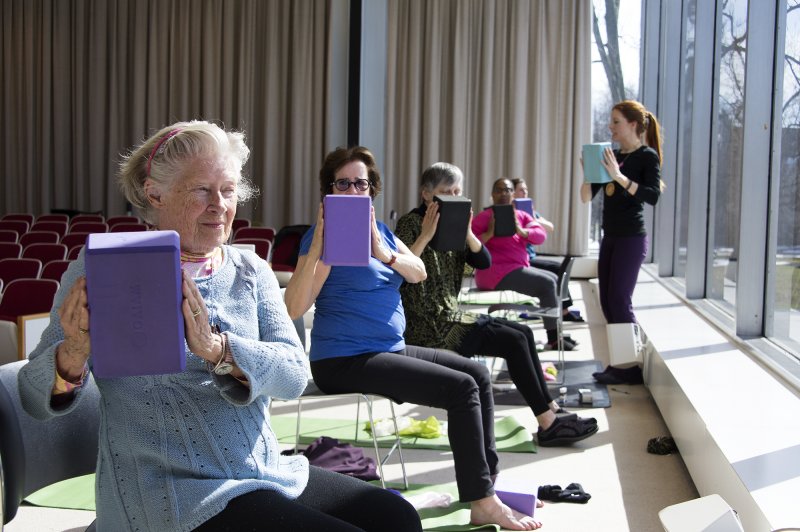 Women in chairs doing yoga twists