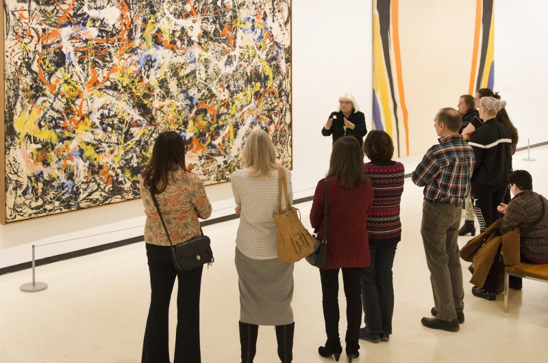 Visitors on a tour in front of Jackson Pollock's Convergence, 1952