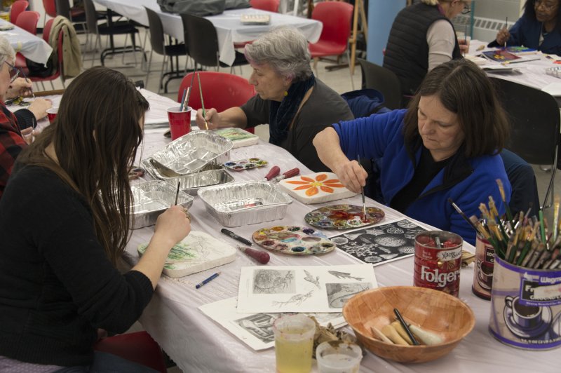 Adults making art in the classroom